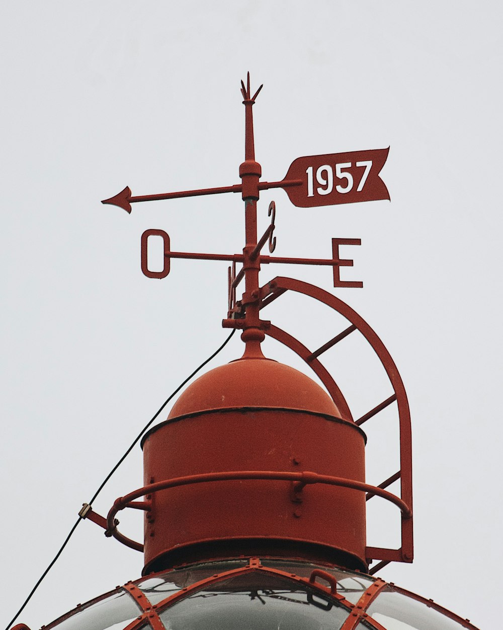 a red weather vane on top of a building
