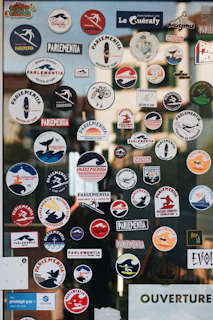 a bunch of stickers on a glass door