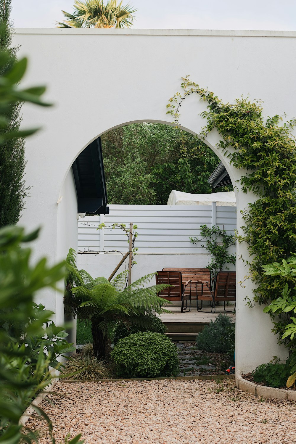 a garden area with a table and chairs