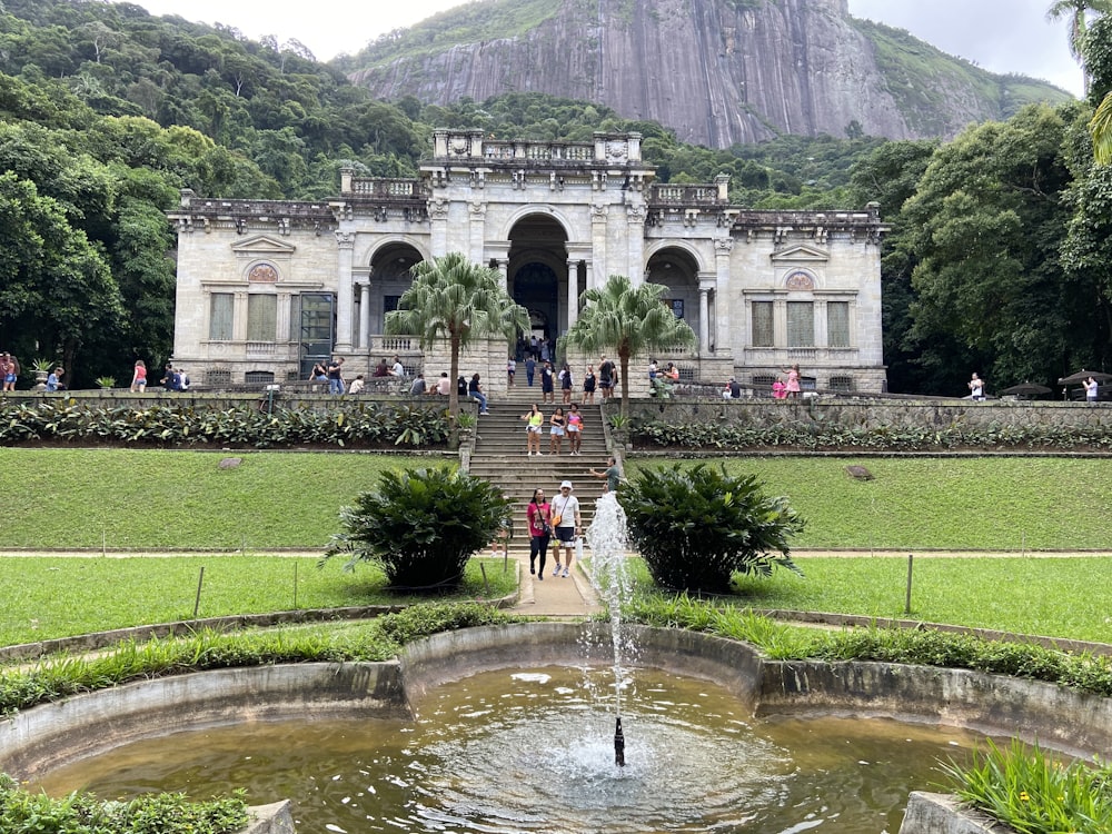 a large building with a fountain in front of it