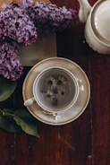 a cup of tea sitting on top of a wooden table