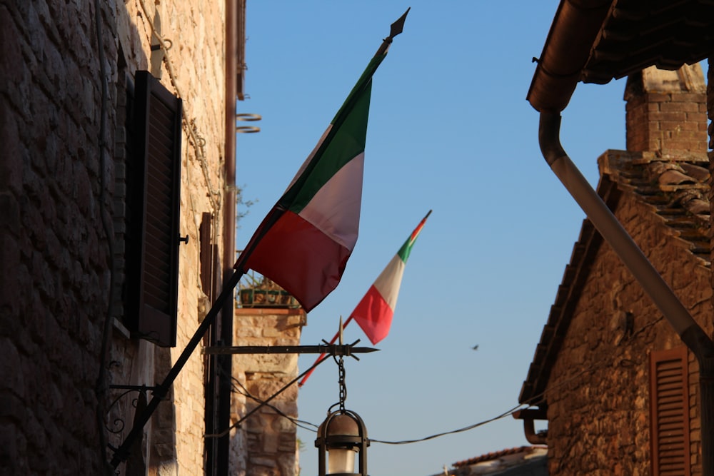 a flag flying in the wind next to a building