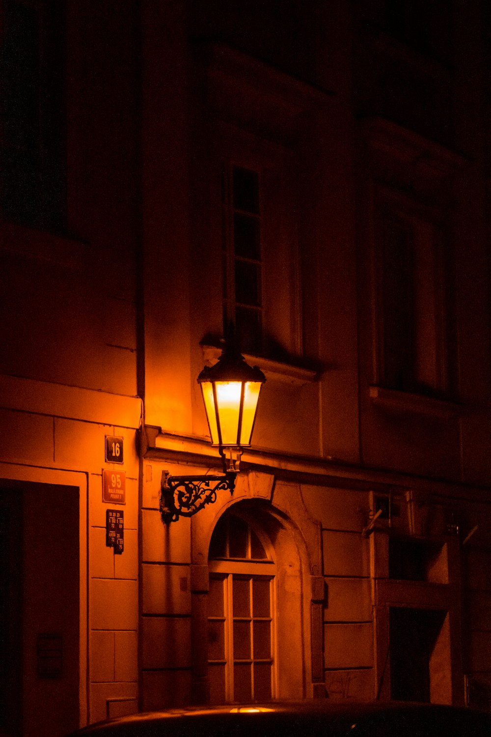 a car parked in front of a building at night