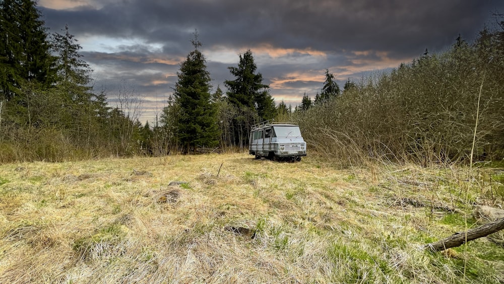 a van parked in the middle of a field