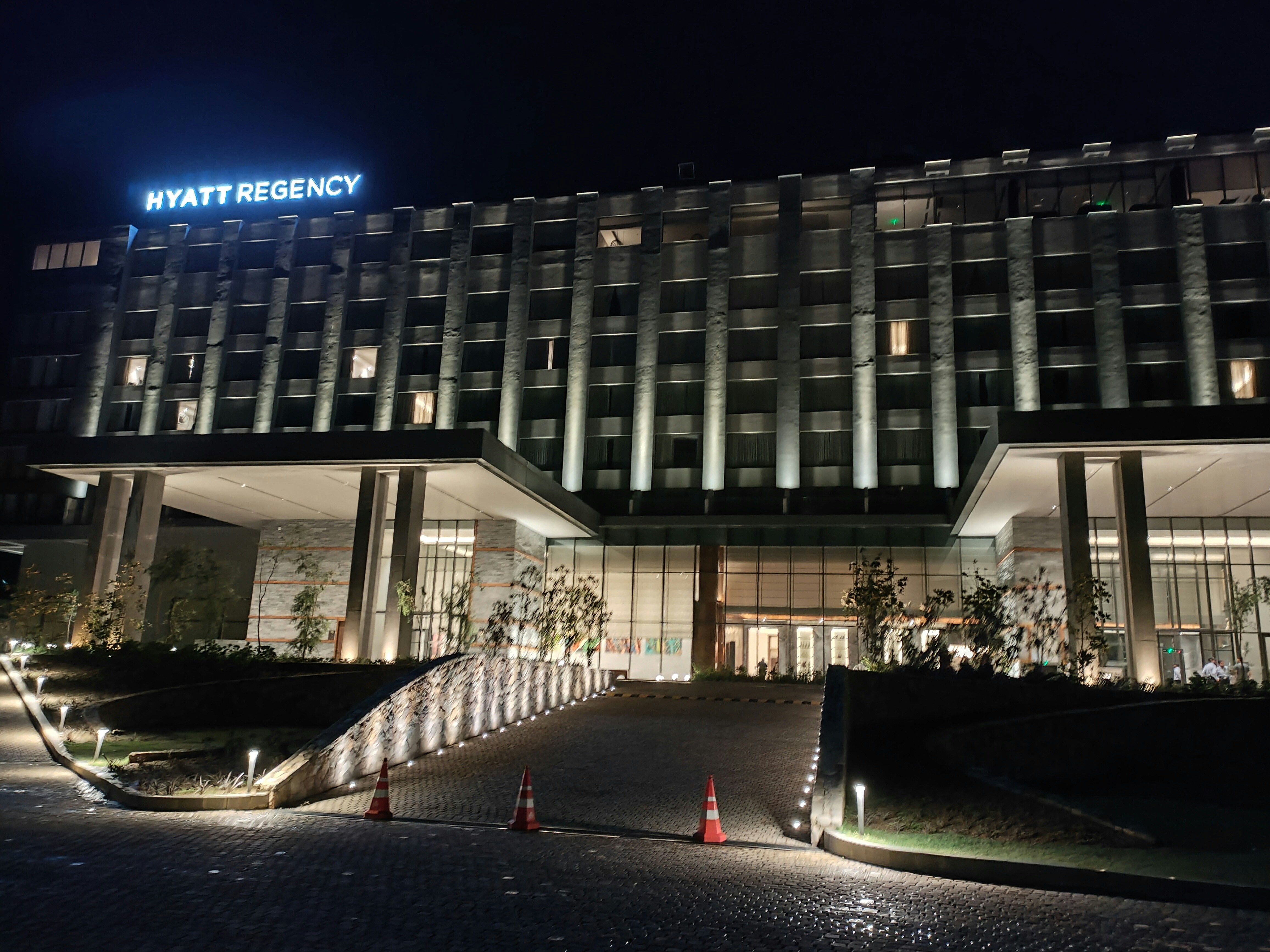 a large building lit up at night with lights on, 