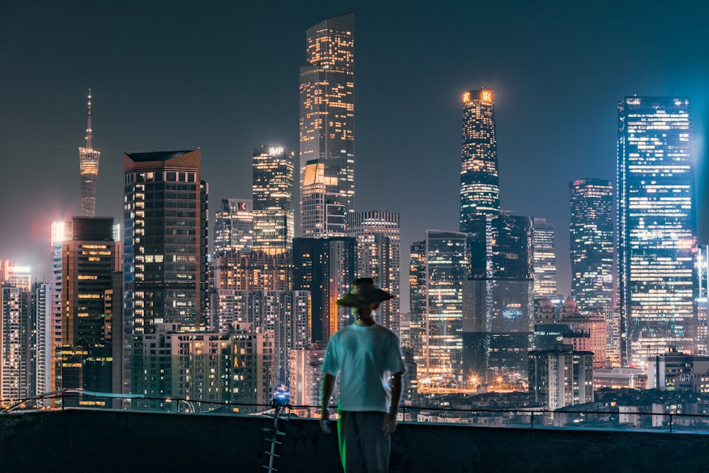 a man standing on top of a roof with a scooter