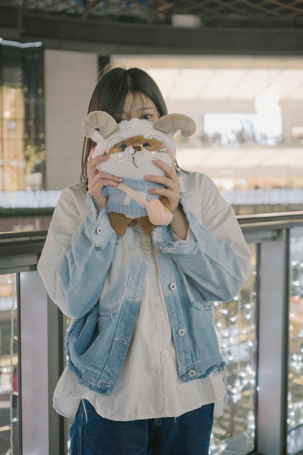 a woman holding a stuffed animal in front of her face