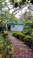 A charming house exterior with a well-kept garden and pathway.