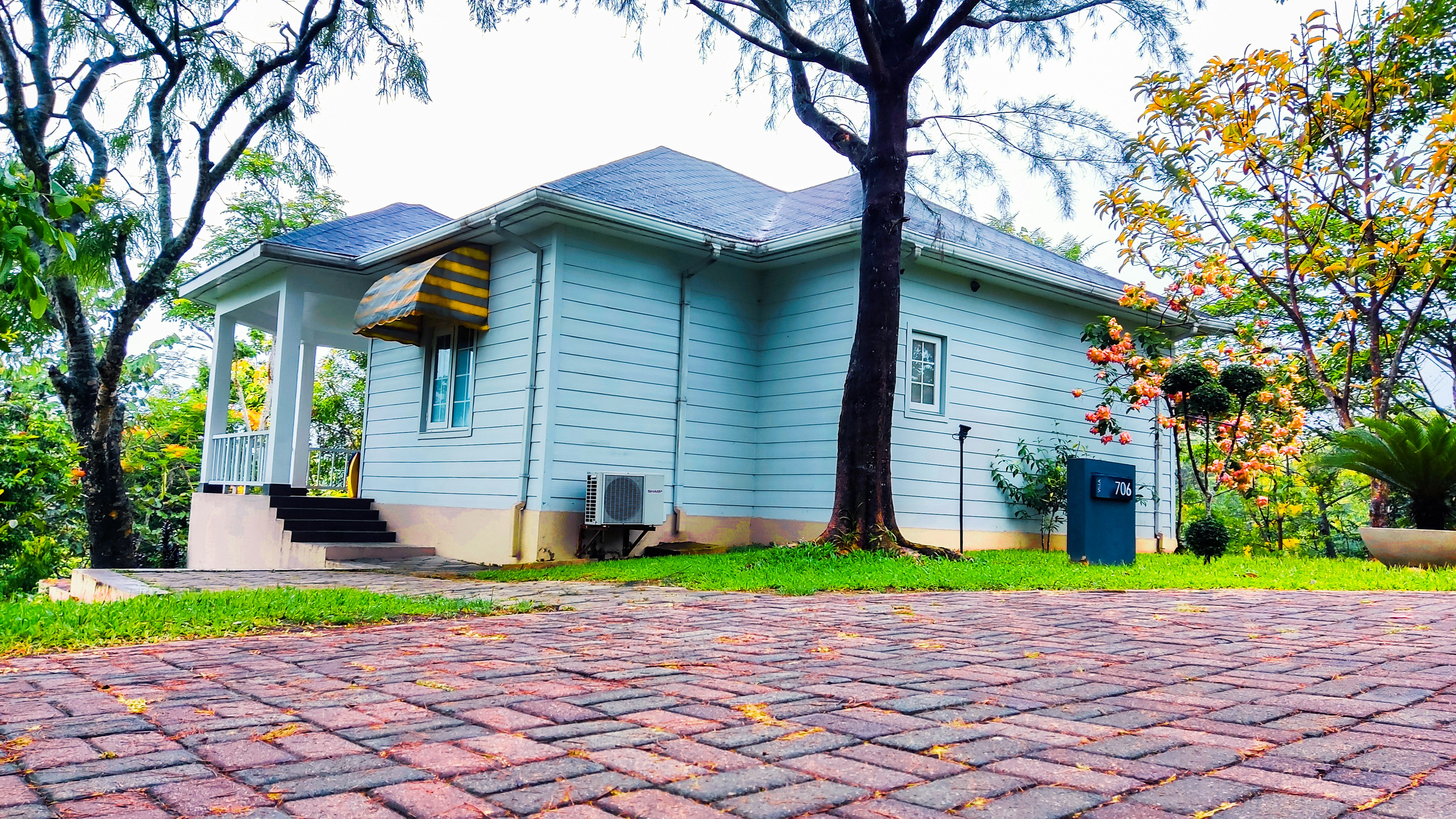 a blue house sitting on top of a lush green field