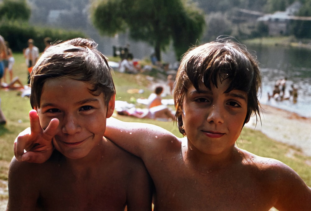 a couple of young boys standing next to each other