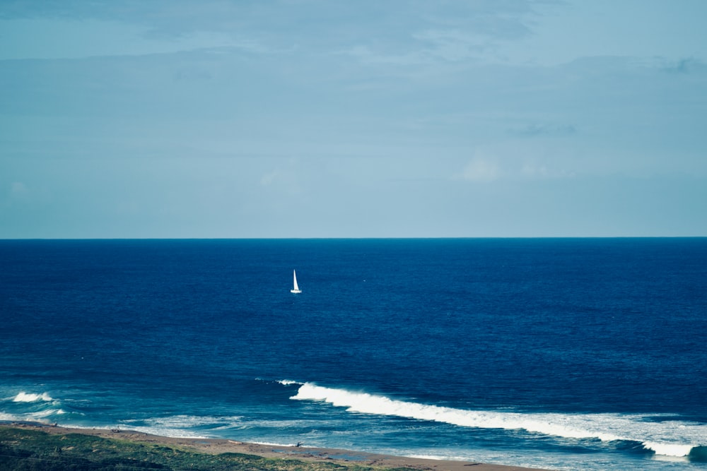 a sailboat is out in the open ocean