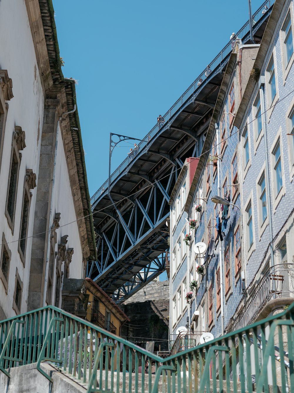 a view of a building with a bridge in the background