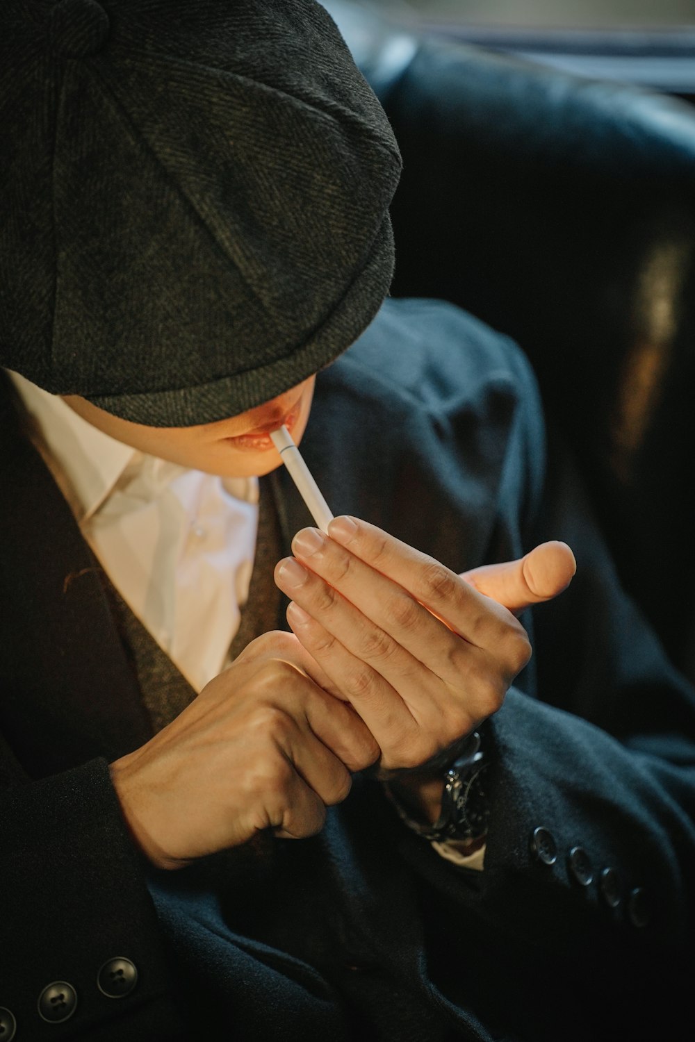 a man in a suit smoking a cigarette