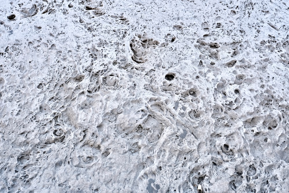 a snow covered hill with footprints in the snow