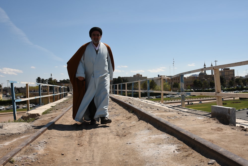 a man is standing on a train track