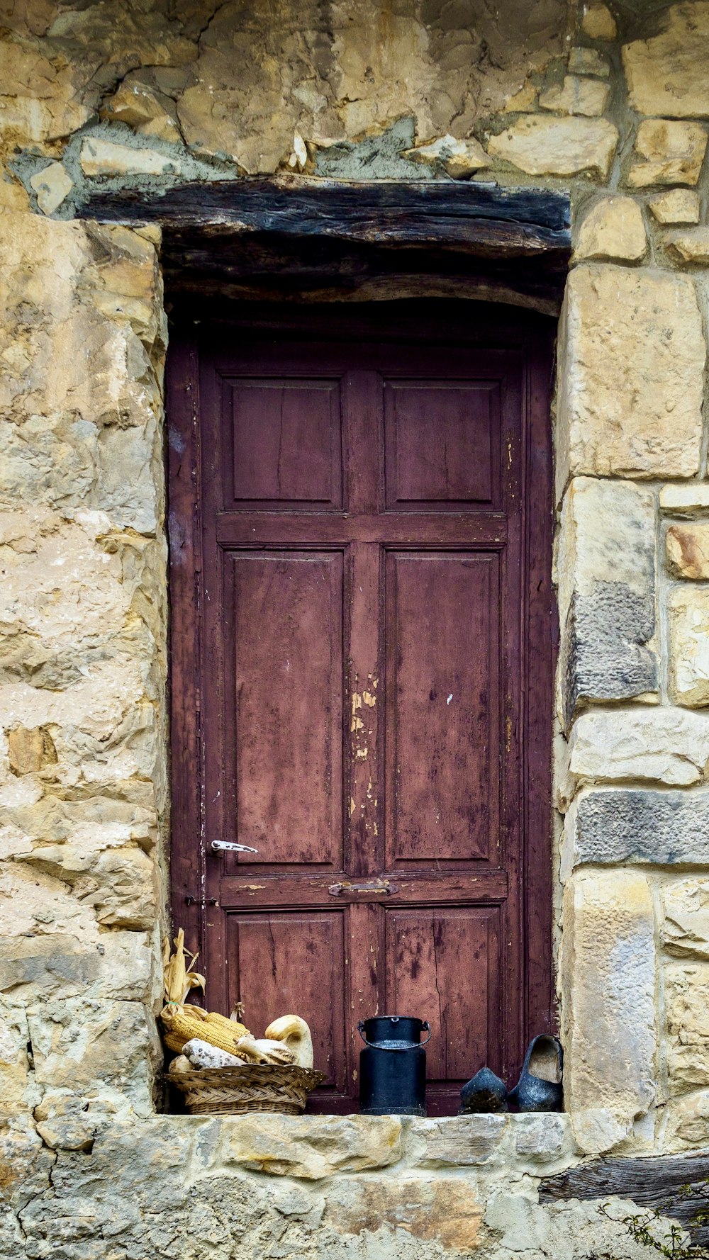 a pair of shoes sitting on a ledge in front of a door