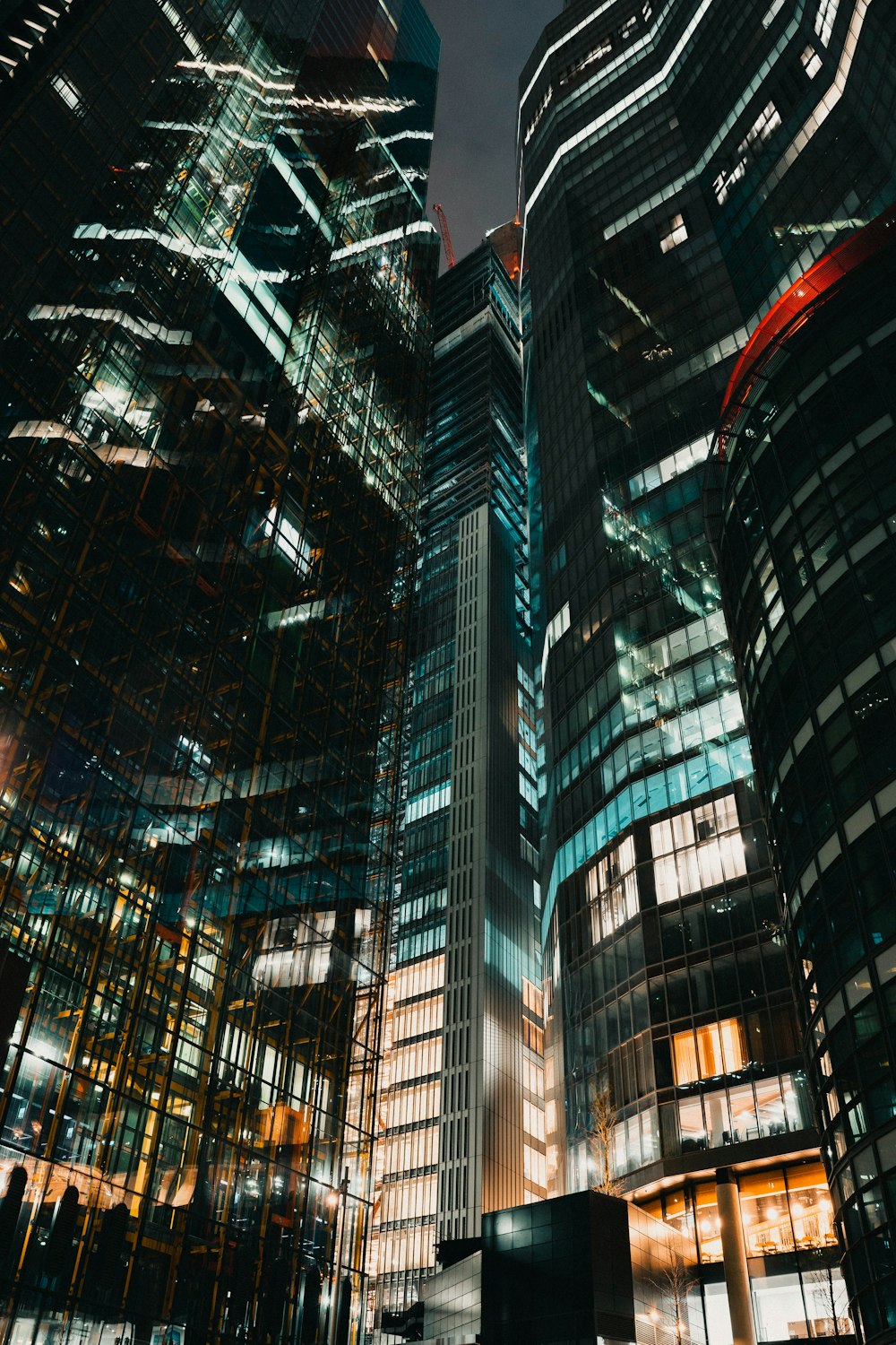 a group of tall buildings in a city at night