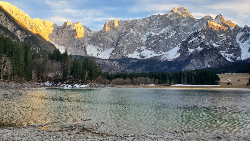 a mountain range with a lake in the foreground