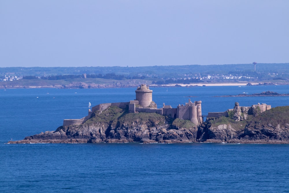 a castle on a small island in the middle of the ocean