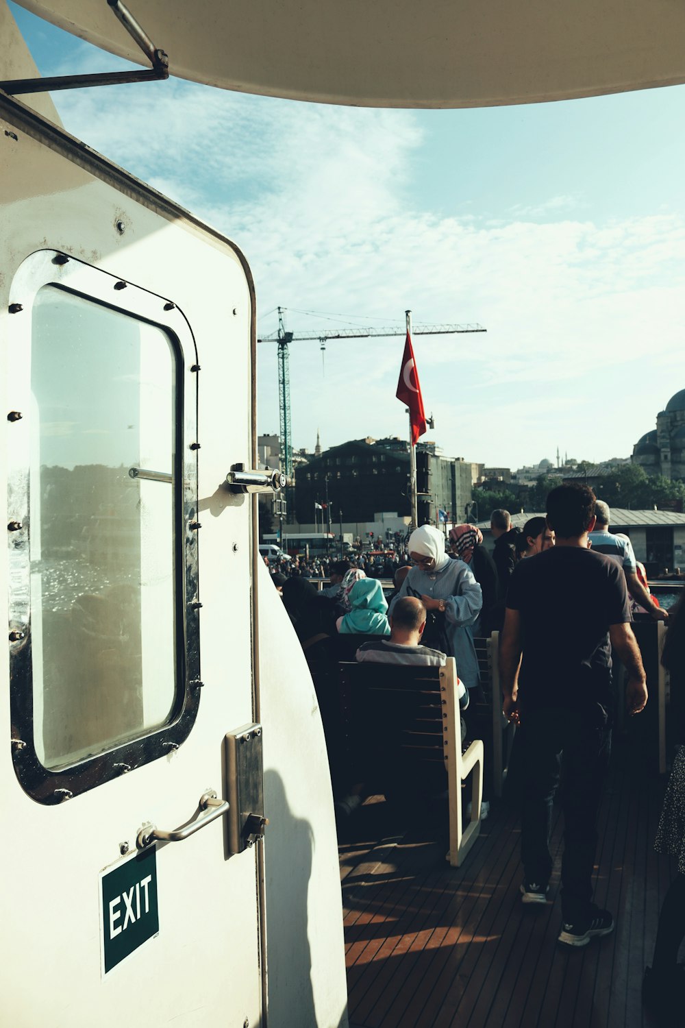 a group of people standing on top of a boat