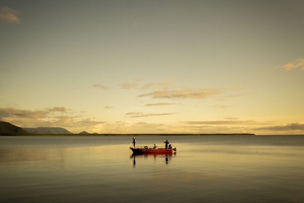 two people in a small boat on a large body of water