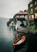 a small boat tied to a dock in a body of water