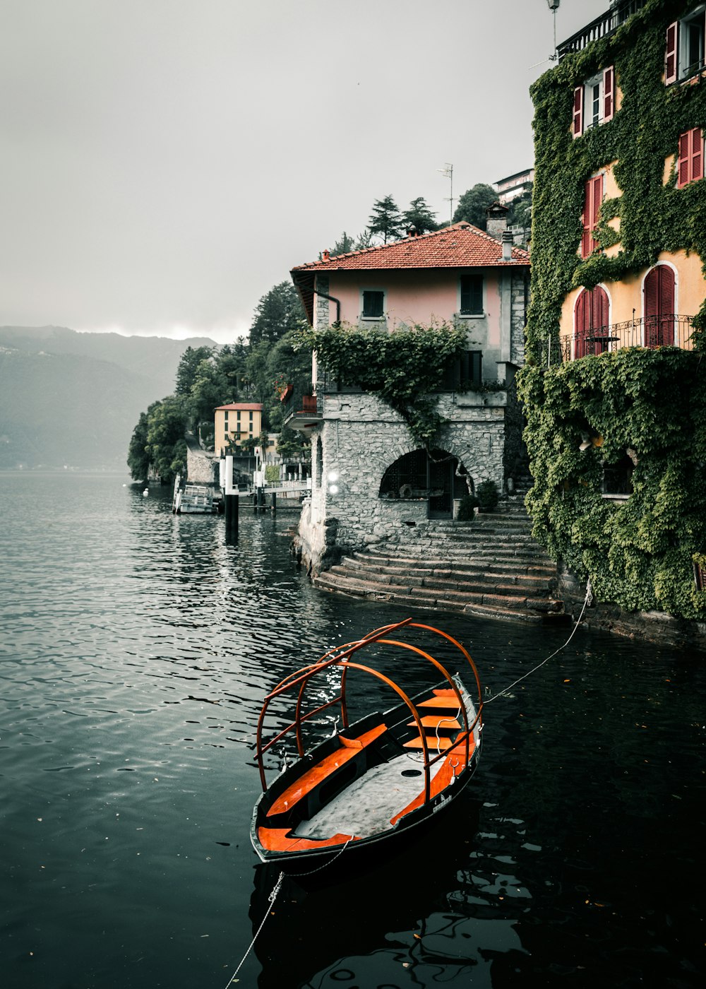 a small boat tied to a dock in a body of water