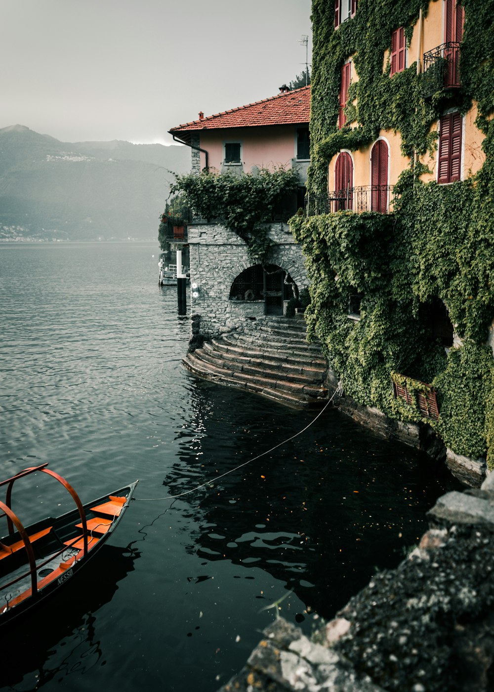 a boat in a body of water next to a building