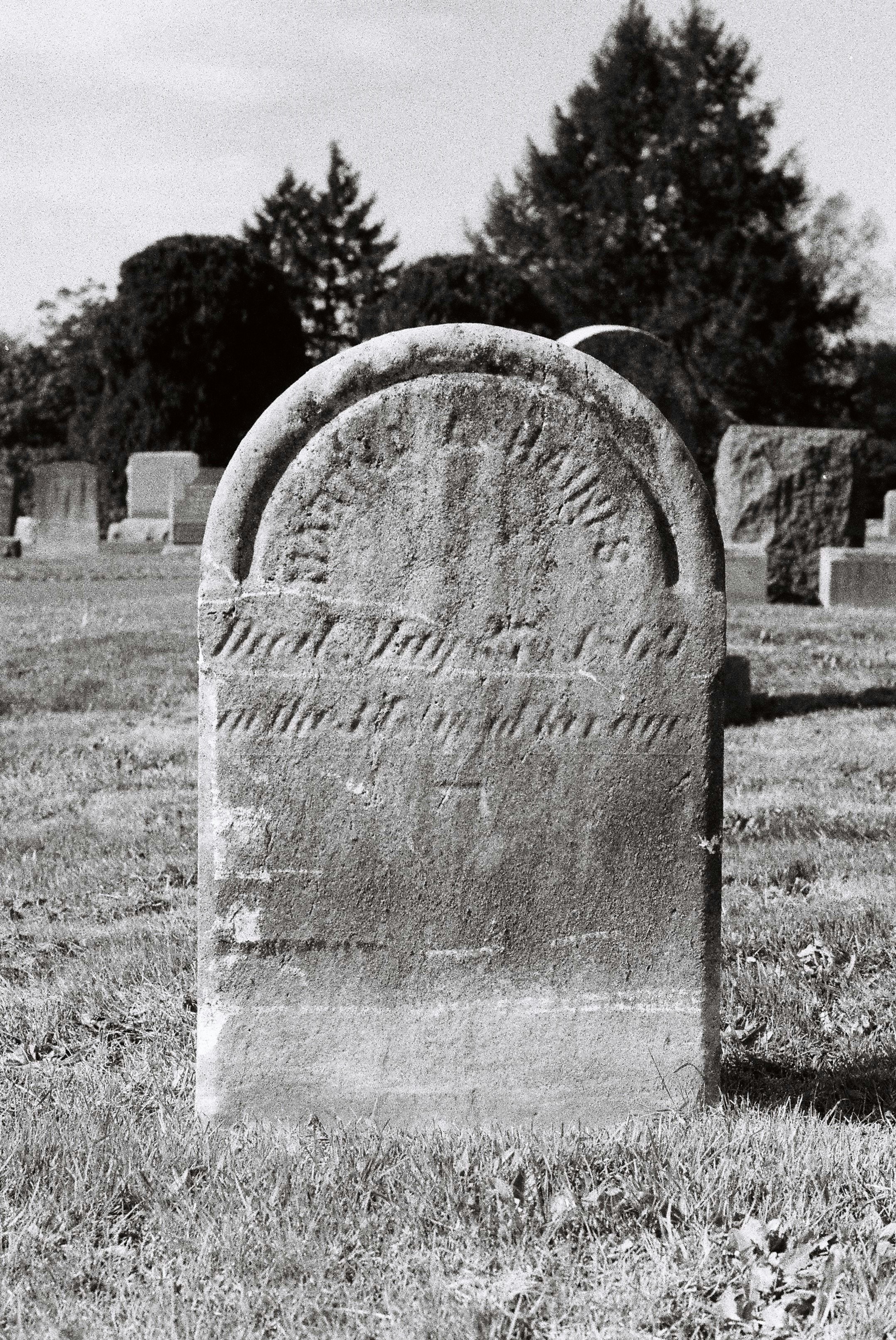 Very old, worn stone. Others in the cemetery date back to the 1700s. Shot on Minolta SRT-101 with Kentmere 400.