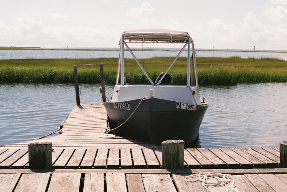 a boat tied to a dock on a body of water