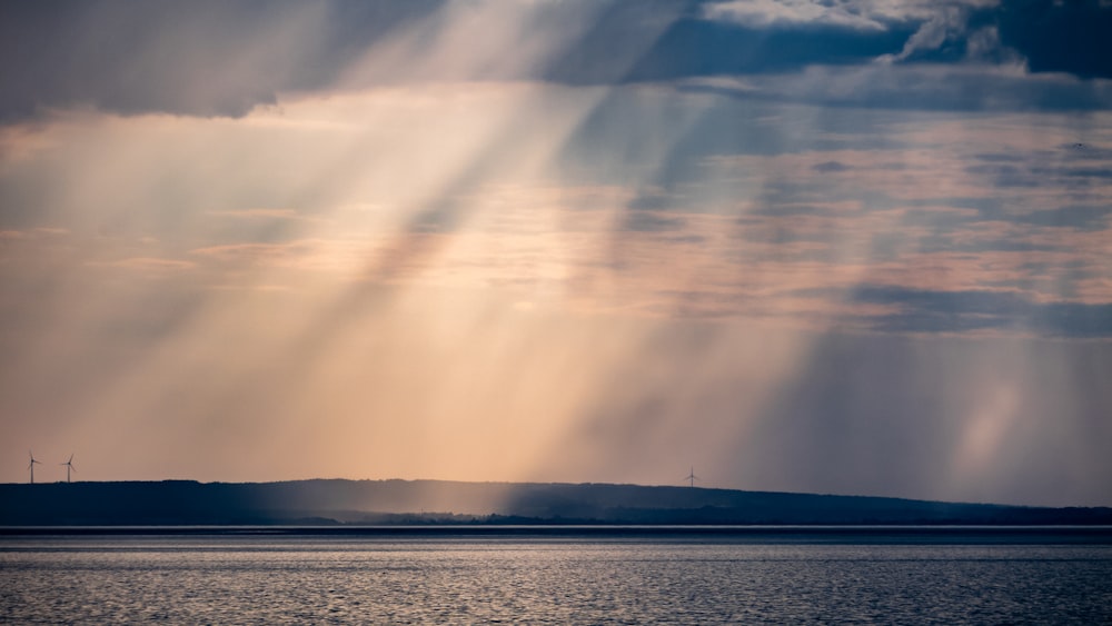 a large body of water under a cloudy sky