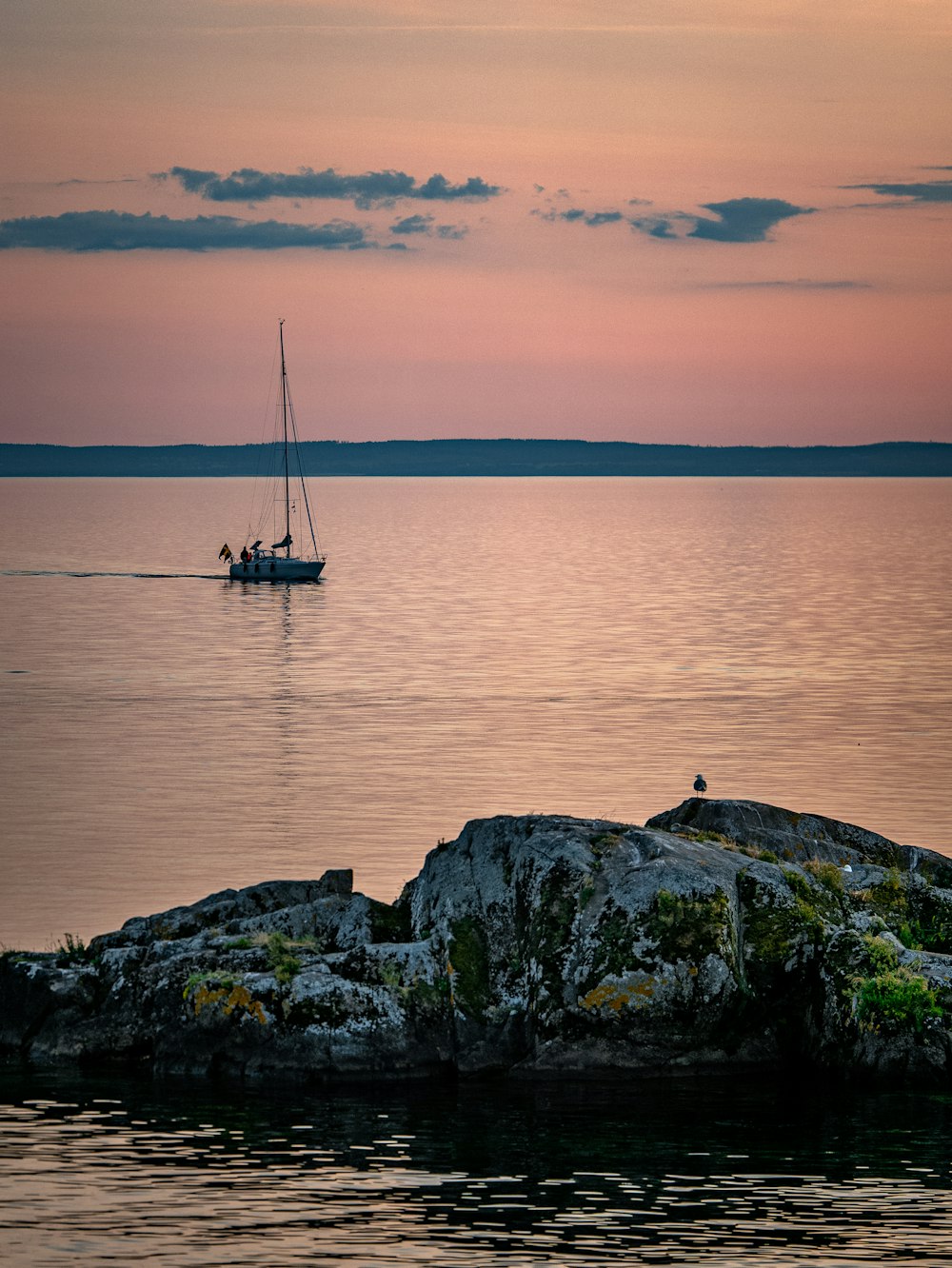 a sailboat on the water at sunset