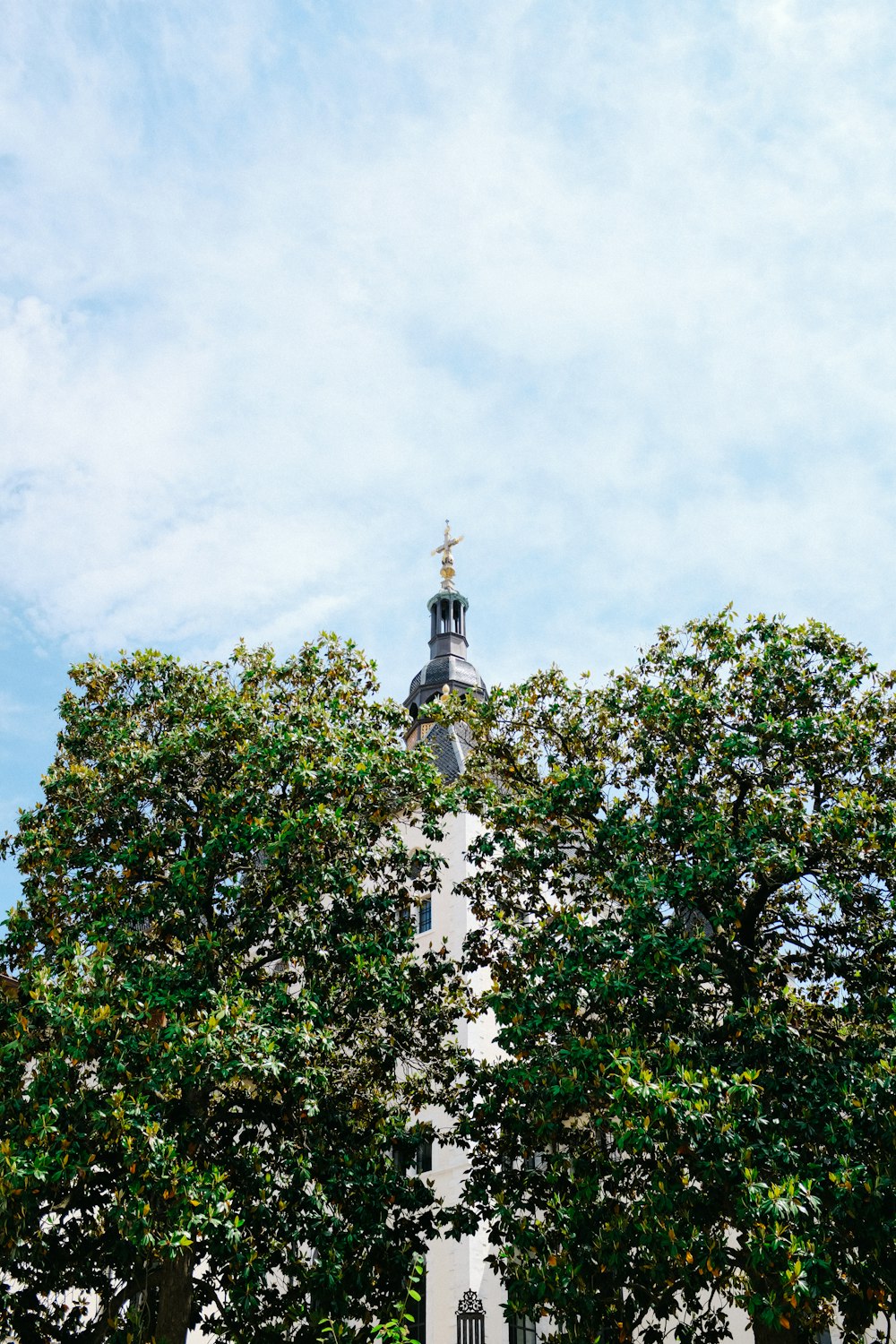 a tall white building with a clock on it's side