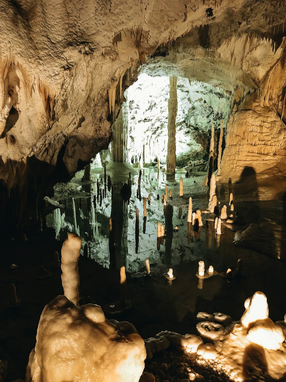 a group of people standing inside of a cave