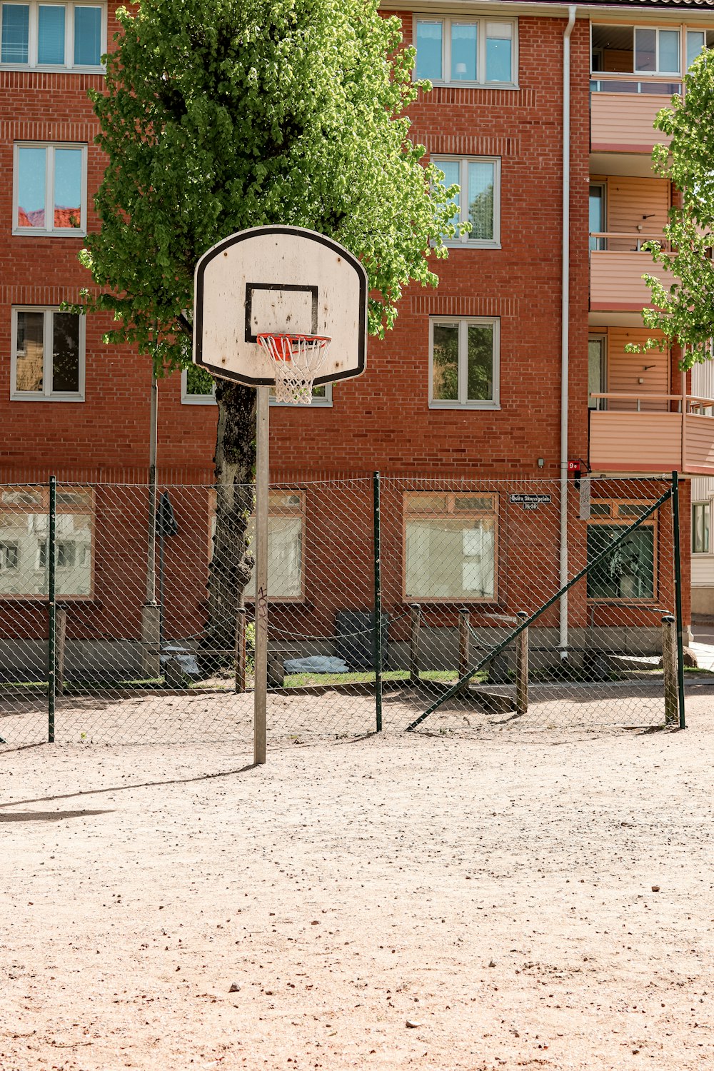 a basketball hoop in front of a brick building