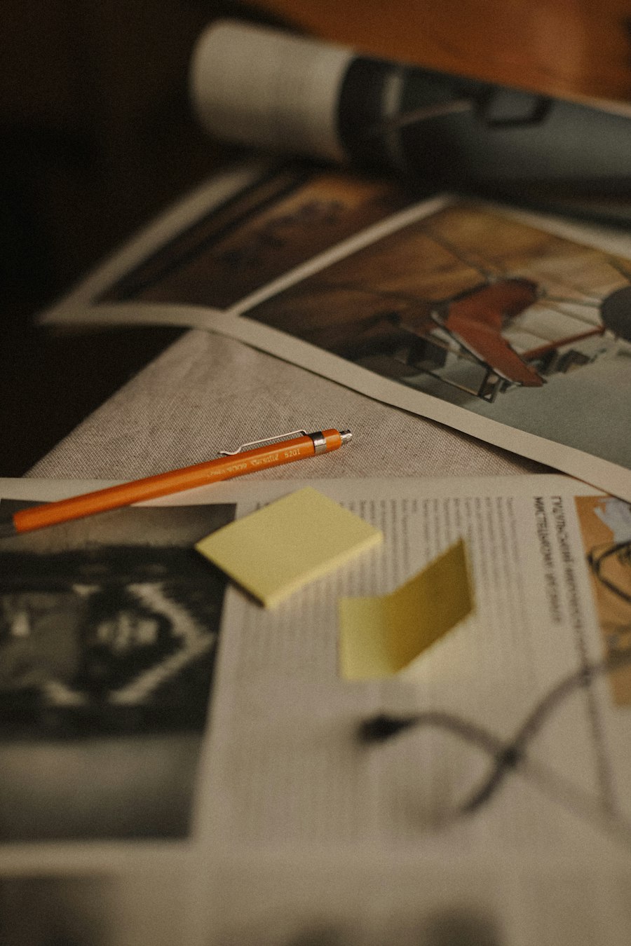 Rolled building plans and pencil on a desk