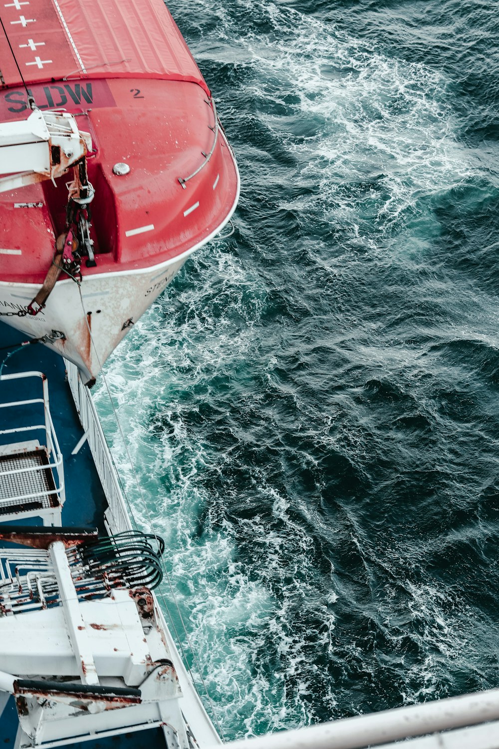 a red and white boat in the water