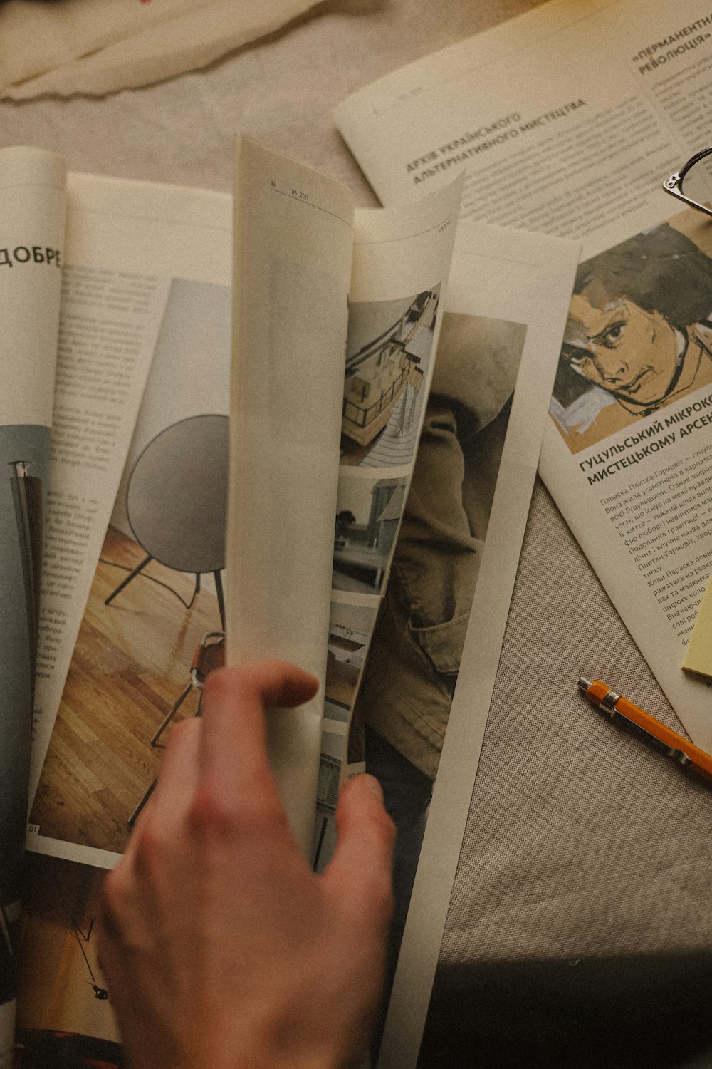 a person is reading a magazine on a bed