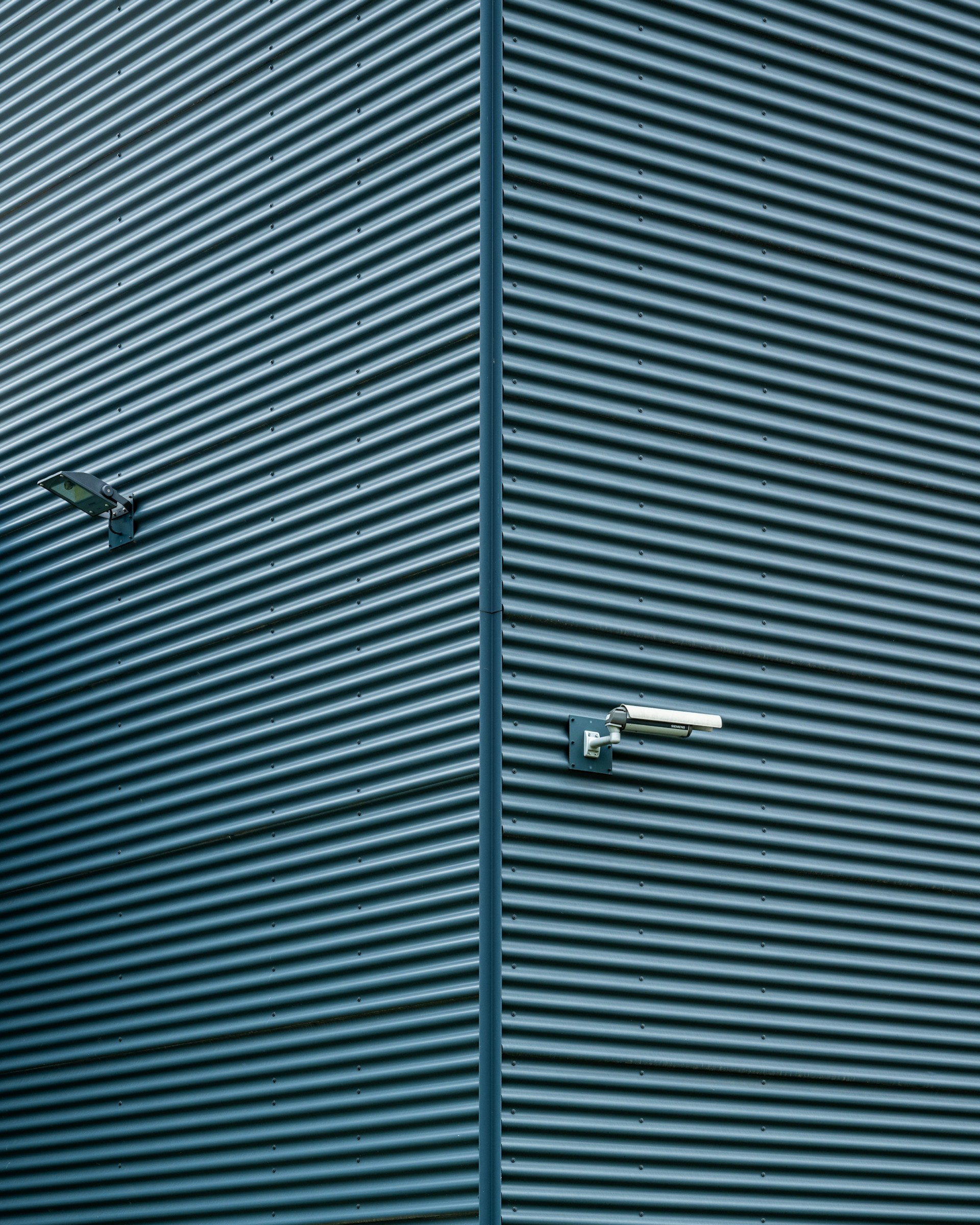 a blue building with a clock on the side of it