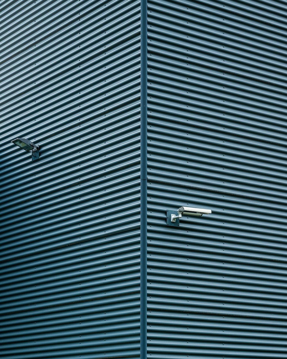 a blue building with a clock on the side of it