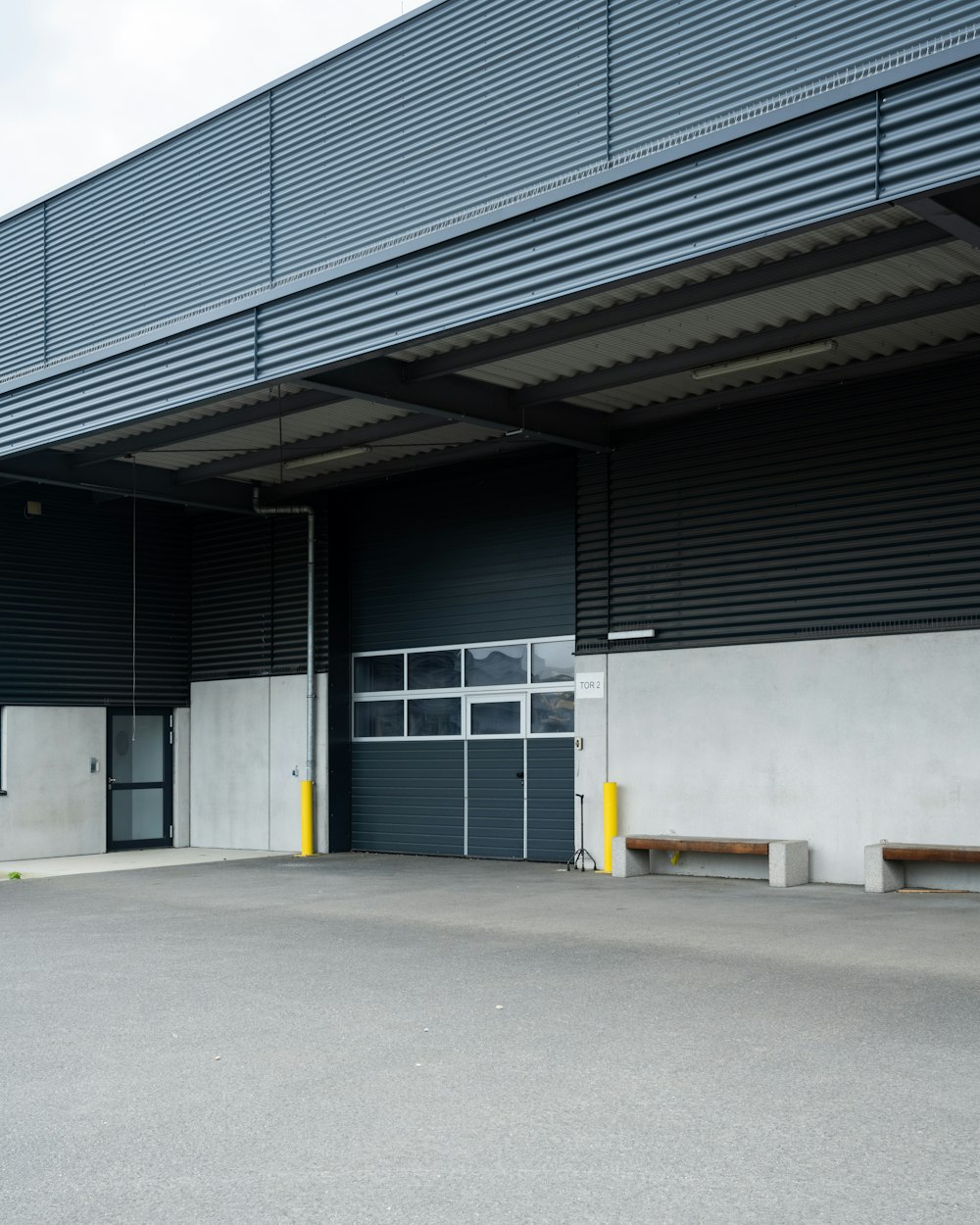 an empty parking garage with a bench in front of it