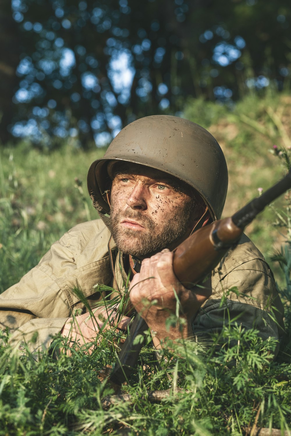 a man wearing a helmet and holding a rifle