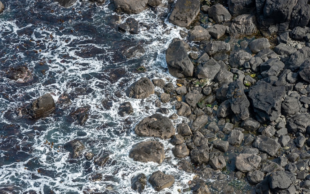 a bird's eye view of the ocean and rocks