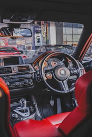 the interior of a car with red leather seats