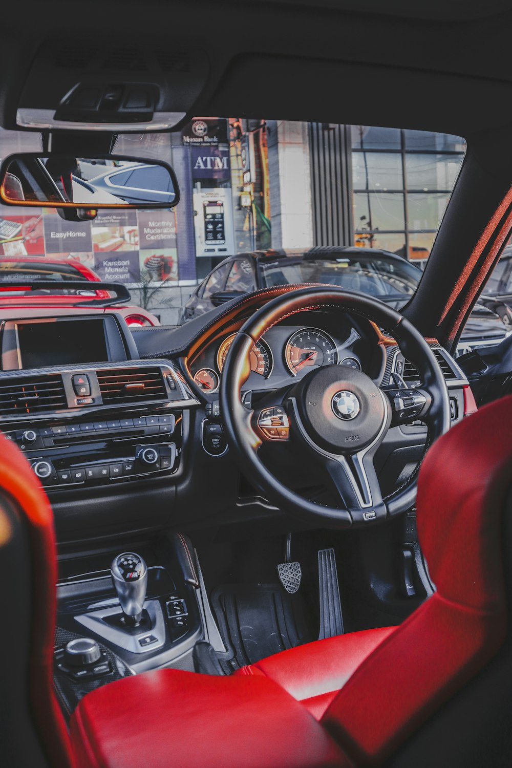 the interior of a car with red leather seats