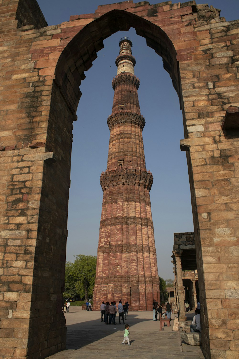 a tall brick tower with a clock on it's side