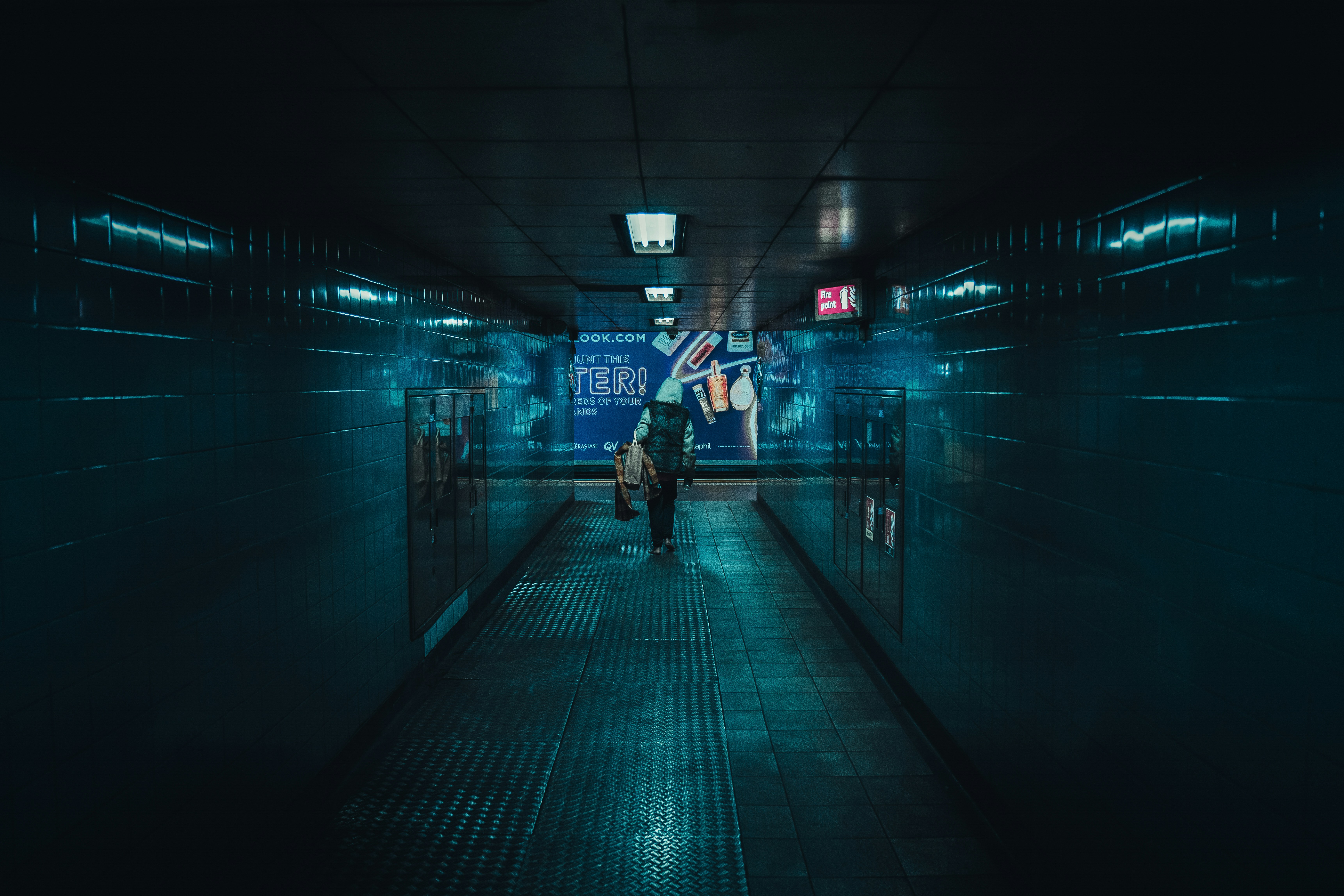 a person walking down a hallway in a building