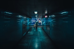 a person walking down a hallway in a building