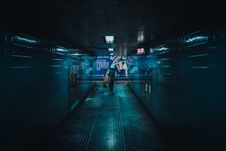 a person walking down a hallway in a building