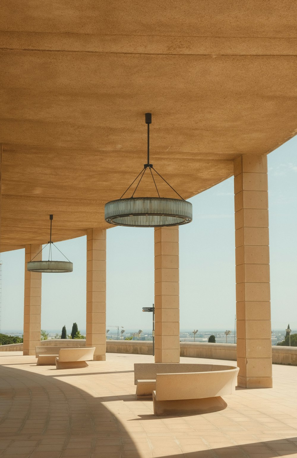 a row of benches sitting under a roof